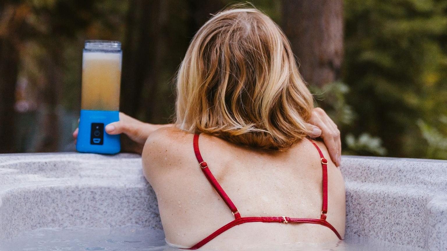 woman holding blender bottle